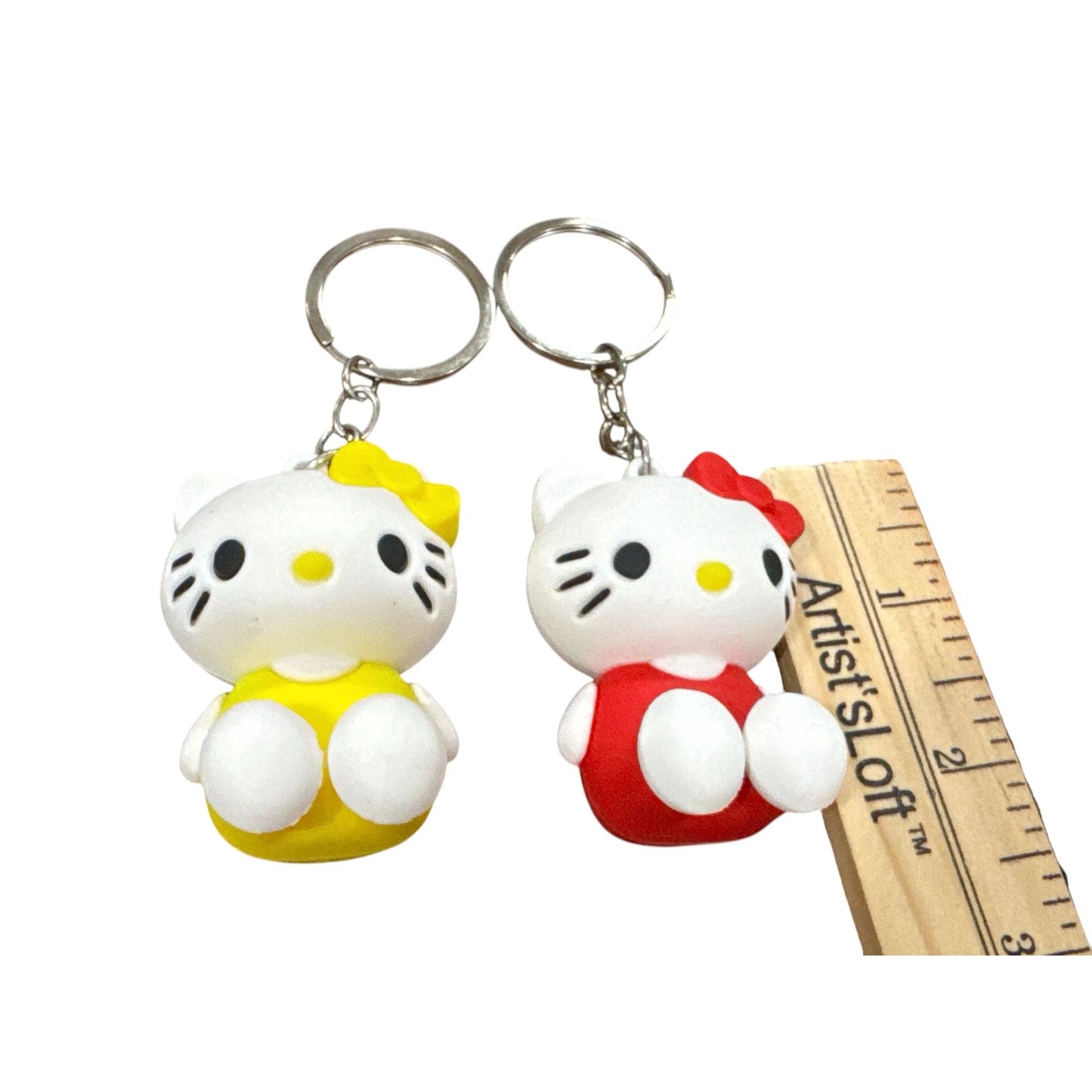 Hello Kitty Keychains Set Of 2 With Red & Yellow Outfits 3D Rubber Design 2 Inches Tall