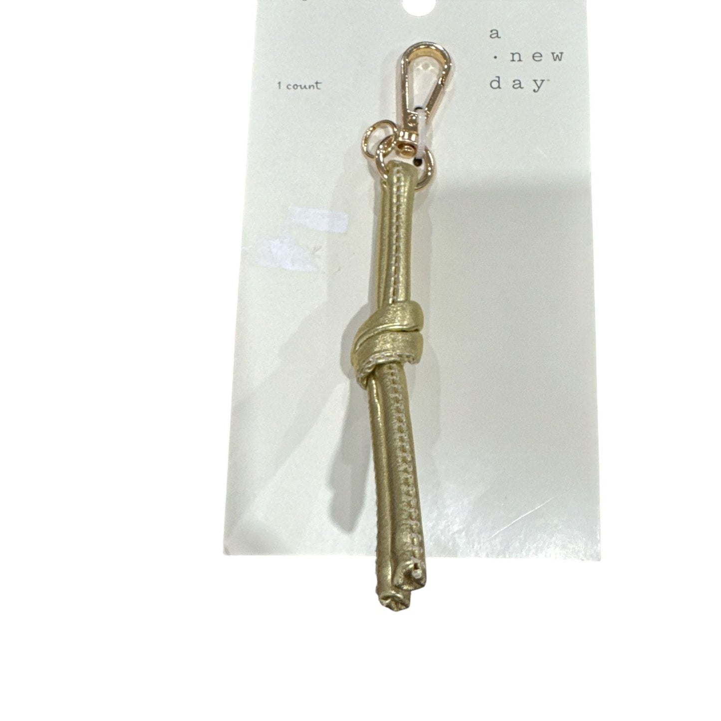 Set Of 2 Keychains: A New Day Gold Knot Bag Charm & Universal Thread Sweet Relish Keychain