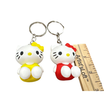 Hello Kitty Keychains Set Of 2 With Red & Yellow Outfits 3D Rubber Design 2 Inches Tall